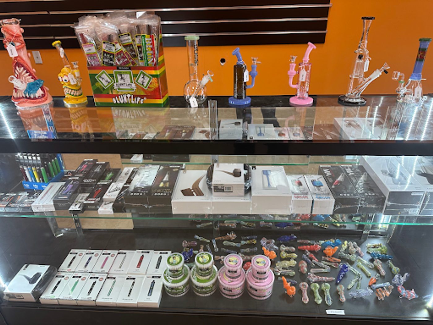 Glass display case with glassware and accessories